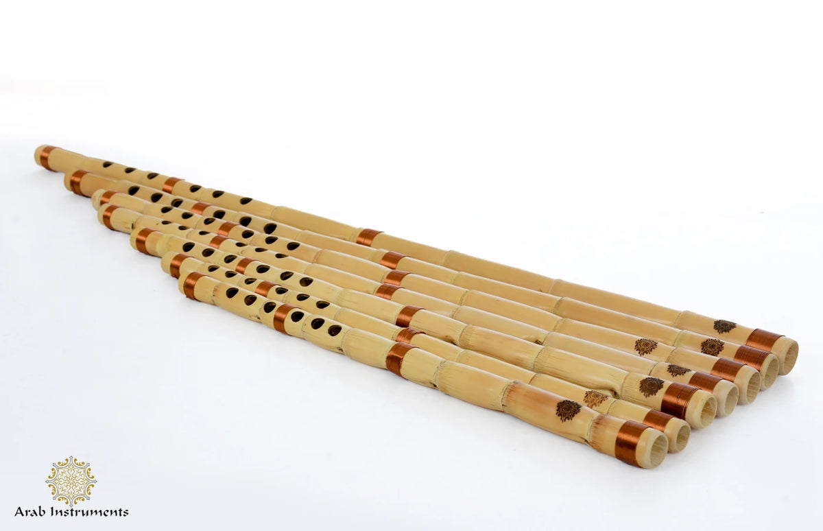 Egyptian ney set by Alsaid Bayomy with seven natural reed flutes arranged diagonally on a white background